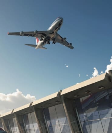 Flugzeug fliegt über ein Flughafengelände